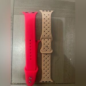 These are two silicone Apple Watch sport-style bands, one bright pink and pink